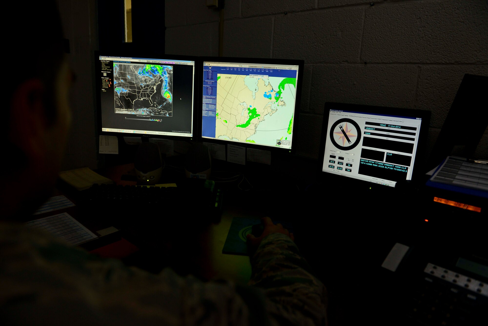 U.S. Air Force Tech. Sgt. John Apple, 1st Operations Support Squadron weather flight assistant section chief, checks different sources to follow the current weather at Fort Eustis, Va., Oct. 17, 2014. The weather flight members make sure aircraft are good to fly in- and out of Felker Army Airfield, and they inform the general Fort Eustis public of any severe weather. (U.S. Air Force photo by Airman 1st Class Kimberly Nagle/Released)