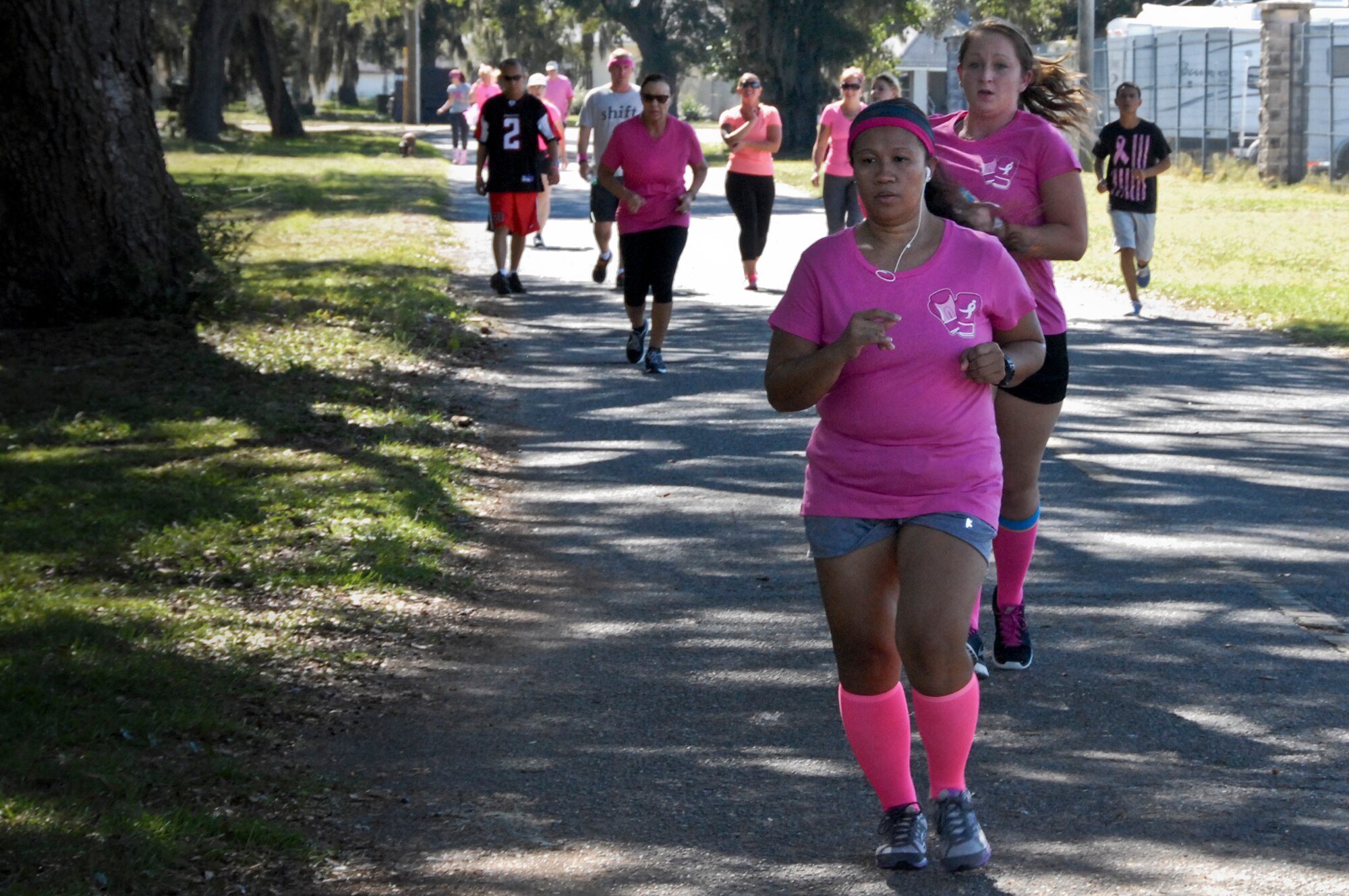 Runners approach the halfway point of the 7th Annual Breast Cancer Awareness 5k run Oct. 17 at Eglin Air Force Base, Fla.  Civilian Health Promotion Services was also on hand providing information on breast cancer risk factors, symptoms and screenings.  The event was held to promote breast cancer awareness and the importance of self-examination to catch the disease in its early stages.  (U.S. Air Force photo/Kevin Gaddie)