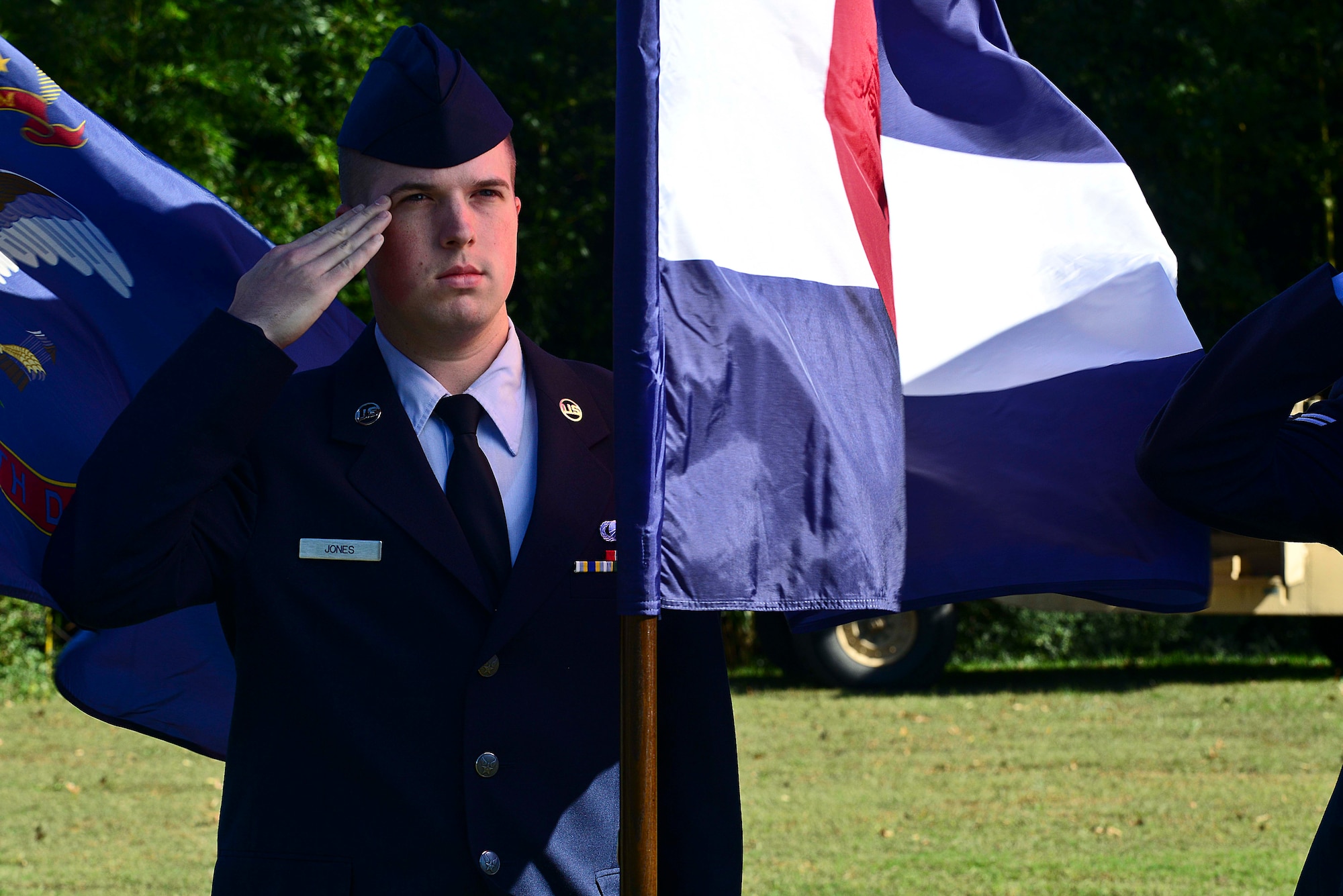 U.S. Air Force Airman 1st Class Marshall Jones, 633rd Comptroller Squadron travel pay technician, salutes during the playing of the National Anthem, at the annual Yorktown Day celebration, in Yorktown, Va., Oct. 19, 2014. Jones took part in the parade and the Parade of Flags. (U.S. Air Force photo by Airman 1st Class Kimberly Nagle/ Released)