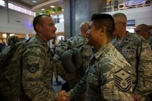 Deployers from the North Dakota Air National Guard’s 219th Security Forces Squadron are welcomed home after a six-month deployment to Southwest Asia on Oct. 15, 2014. About 15 Airmen landed at Minot International Airport where they were greeted by family members and other Airmen from the 219th SFS (U.S. Air Force photo/Airman 1st Class Lauren Pitts) 