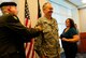 U.S. Army Master Sgt. (ret.) David Foster (left), brother, and Karen Foster (right), spouse, tack chevrons onto U.S. Air Force Chief Master Sgt. Christopher Foster, 145th Civil Engineer Squadron, during his promotion ceremony held at the North Carolina Air National Guard Base, Charlotte Douglas Intl. Airport, Oct. 4, 2014. (U.S. Air National Guard photo by Staff Sgt. Julianne M. Showalter, 145th Public Affairs/Released)