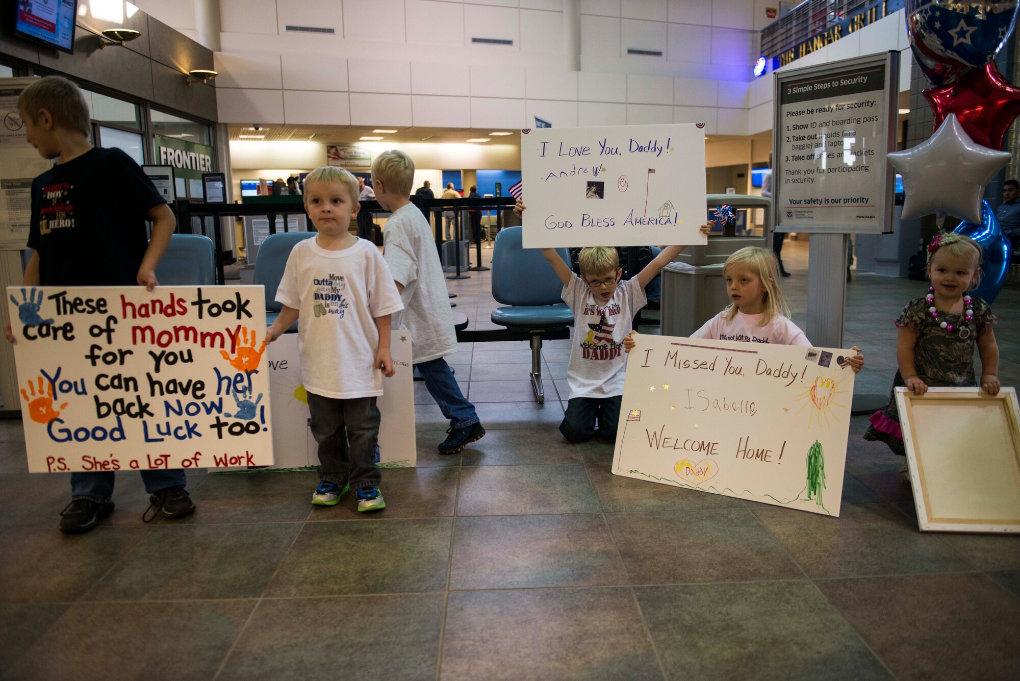 Families wait inside the Minot International Airport to welcome home Airmen from the North Dakota Air National Guard’s 219th Security Forces Squadron, Oct. 15, 2014. About 15 Airmen returned from a six-month deployment to Southwest Asia, where the troops provided support to U.S. Central Command. (U.S. Air Force photos/Airman 1st Class Lauren Pitts)  