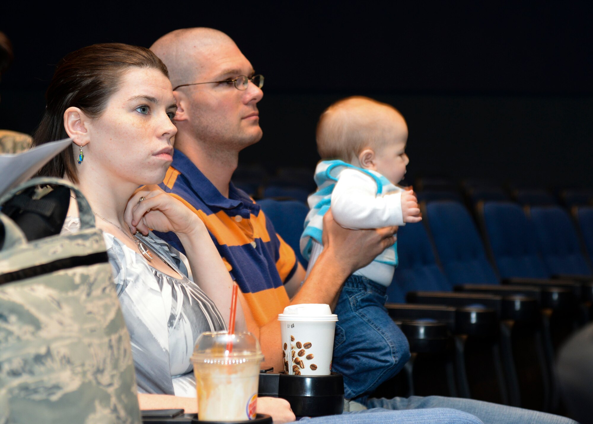U.S. Air Force 1st Lt. Joseph Broeckelmann, 633rd Medical Operations Squadron emergency room nurse, his wife, Krista, and his son, Charles, listen as Col. Wayne Pritt, 633rd Medical Group commander, explains the safety status of the returning 633rd MDG Airmen during a briefing at Langley Air Force Base, Va., Oct. 20, 2014. Family members had a chance to ask any questions about the virus and the 21-day, twice-daily testing the returned Airmen are experiencing. (U.S. Air Force photo by Senior Airman Austin Harvill/Released)