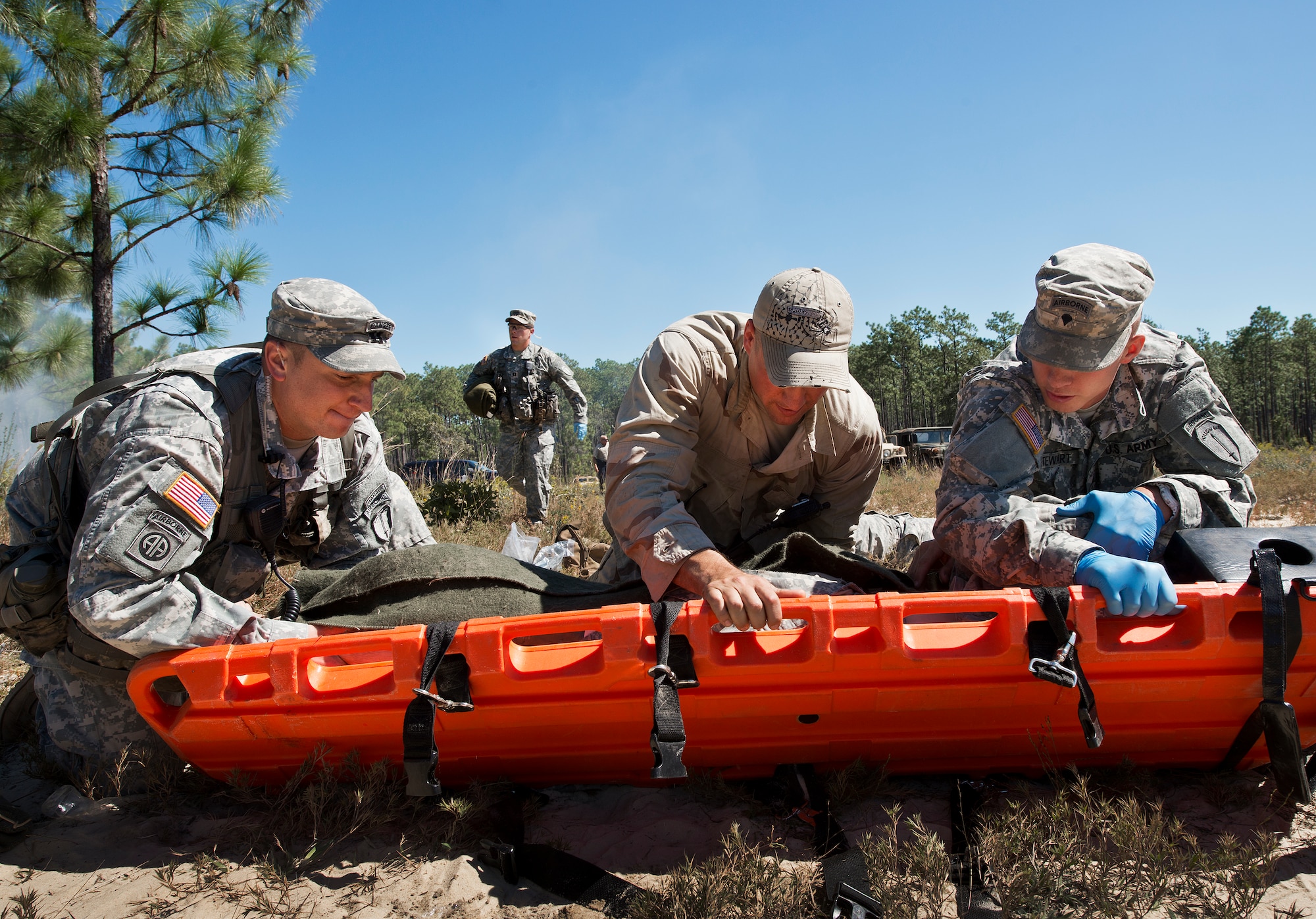 Soldiers roll a simulated victim onto a litter for transport during the 6th Ranger Training Battalion’s annual major accident response exercise Oct. 16 at Eglin Air Force Base, Fla.  Medics and first responders from the 6th RTB, 96th Test Wing and the local area responded to boating and down aircraft scenarios deep within the Eglin range.  (U.S. Air Force photo/Samuel King Jr.)