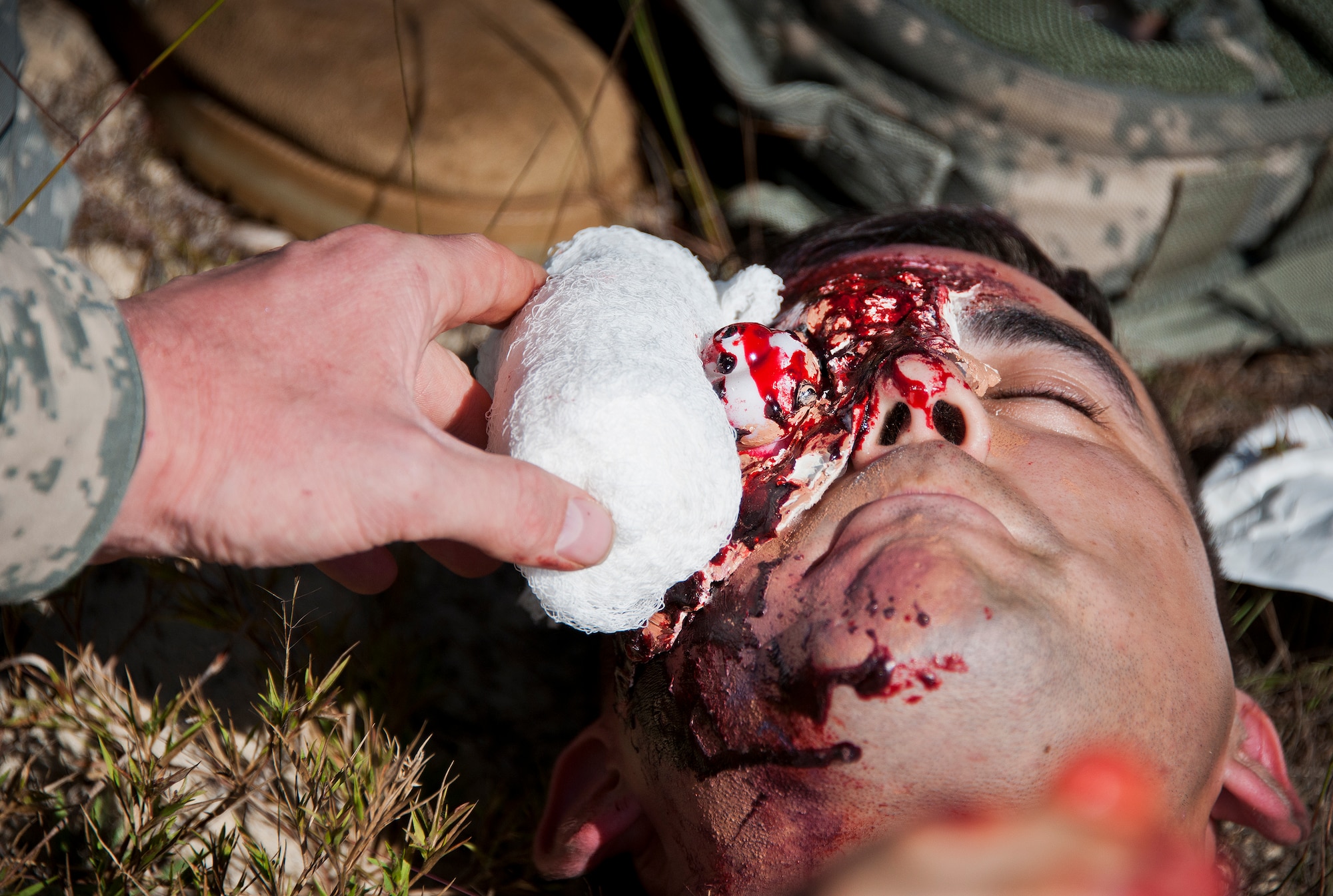 A Soldier uses clean gauze to keep a victim’s simulated eye injury in place during the 6th Ranger Training Battalion’s annual major accident response exercise Oct. 16 at Eglin Air Force Base, Fla.  Medics and first responders from the 6th RTB, 96th Test Wing and the local area responded to boating and down aircraft scenarios deep within the Eglin range.  (U.S. Air Force photo/Samuel King Jr.)