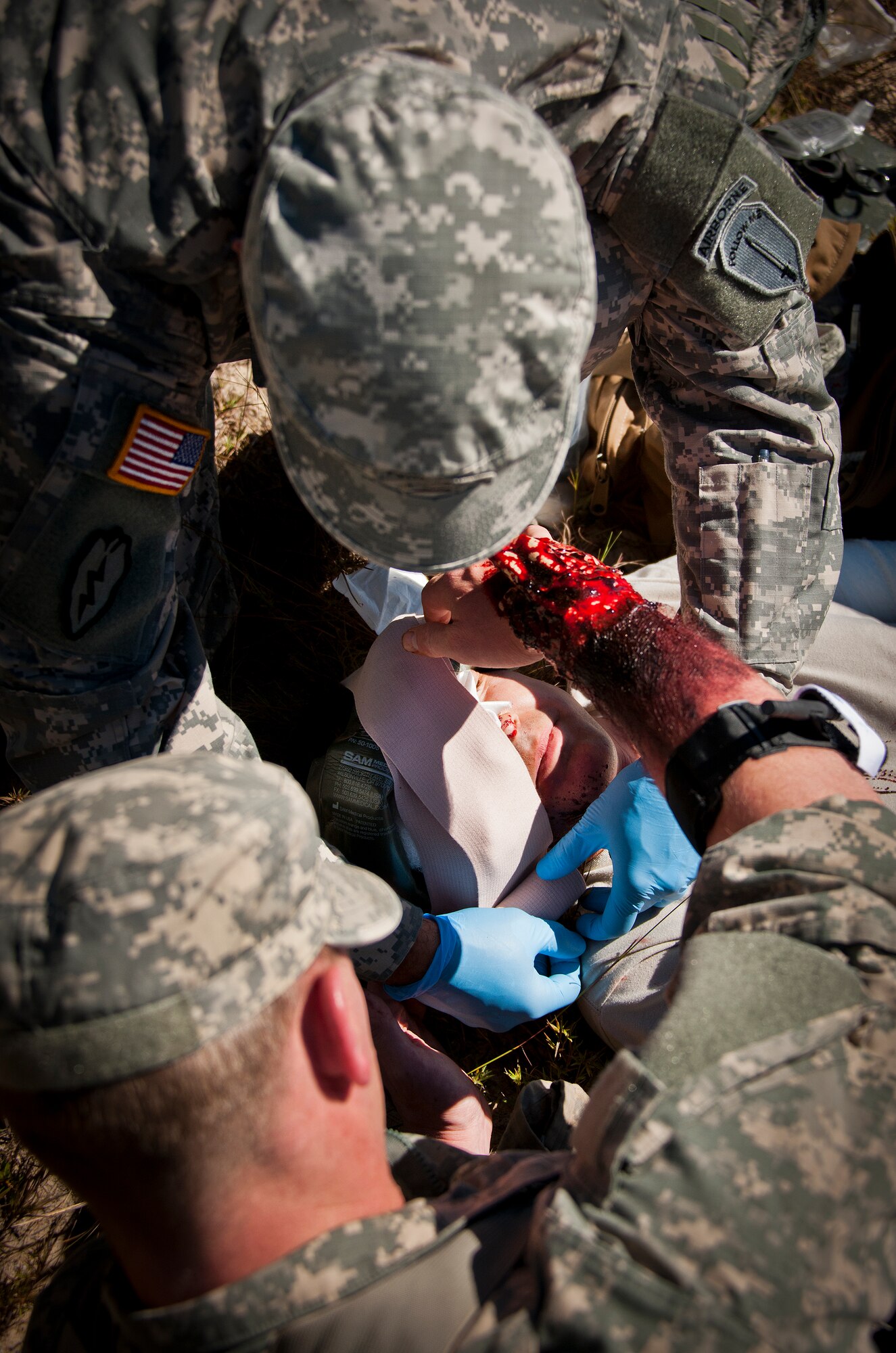 Soldiers apply a field dressing to the head of a simulated victim during the 6th Ranger Training Battalion’s annual major accident response exercise Oct. 16 at Eglin Air Force Base, Fla.  Medics and first responders from the 6th RTB, 96th Test Wing and the local area responded to boating and down aircraft scenarios deep within the Eglin range.  (U.S. Air Force photo/Samuel King Jr.)