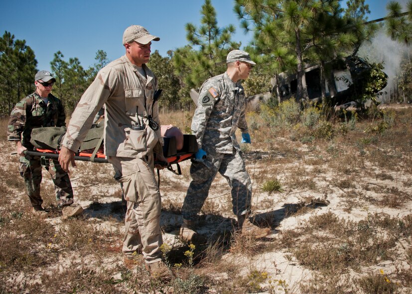Army medical personnel move a simulated helicopter crash victim to a transport vehicle during the 6th Ranger Training Battalion’s annual major accident response exercise Oct. 16 at Eglin Air Force Base, Fla.  Medics and first responders from the 6th RTB, 96th Test Wing and the local area responded to boating and down aircraft scenarios deep within the Eglin range.  (U.S. Air Force photo/Samuel King Jr.)
