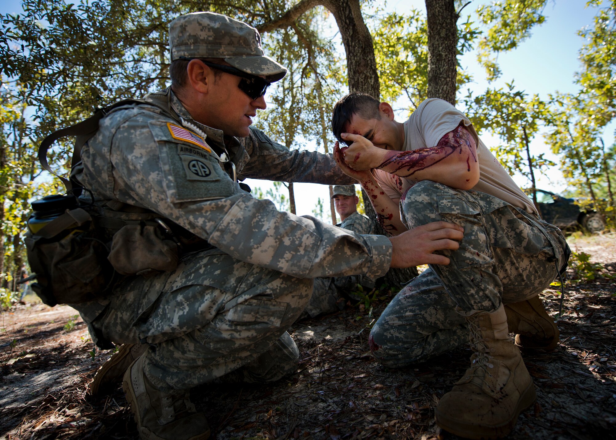 An Army first responder assesses a simulated helicopter crash victim during the 6th Ranger Training Battalion’s annual major accident response exercise Oct. 16 at Eglin Air Force Base, Fla.  Medics and first responders from the 6th RTB, 96th Test Wing and the local area responded to boating and down aircraft scenarios deep within the Eglin range.  (U.S. Air Force photo/Samuel King Jr.)