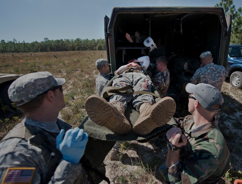 Army medical personnel load a simulated helicopter crash victim into a transport vehicle during the 6th Ranger Training Battalion’s annual major accident response exercise Oct. 16 at Eglin Air Force Base, Fla.  Medics and first responders from the 6th RTB, 96th Test Wing and the local area responded to boating and down aircraft scenarios deep within the Eglin range.  (U.S. Air Force photo/Samuel King Jr.)