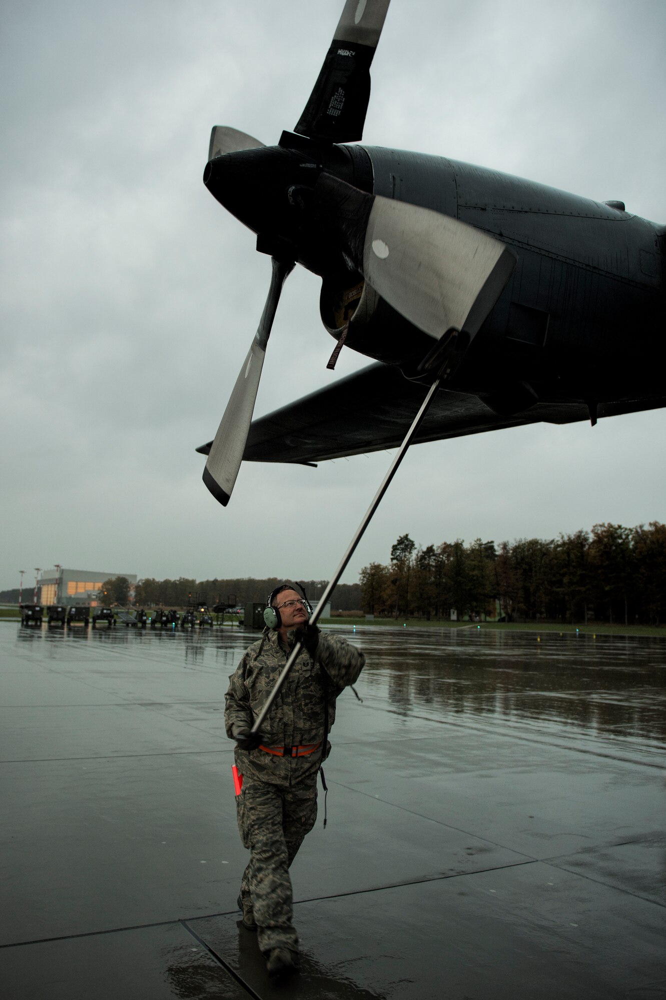 U.S. Air Force Tech. Sgt. Press Chapin, a crew chief of the 182nd Airlift Wing, Illinois Air National Guard, Peoria, Ill., positions the propeller of a C-130 Hercules cargo aircraft at Powidz Air Base, Poland, Oct. 20, 2014. The Illinois Air National Guard and Polish airmen have learned and worked together for more than 20 years on a variety of exercises and events, building interoperability through the partnership program. (U.S. Air Force photo by Staff Sgt. Christopher Ruano/Released)