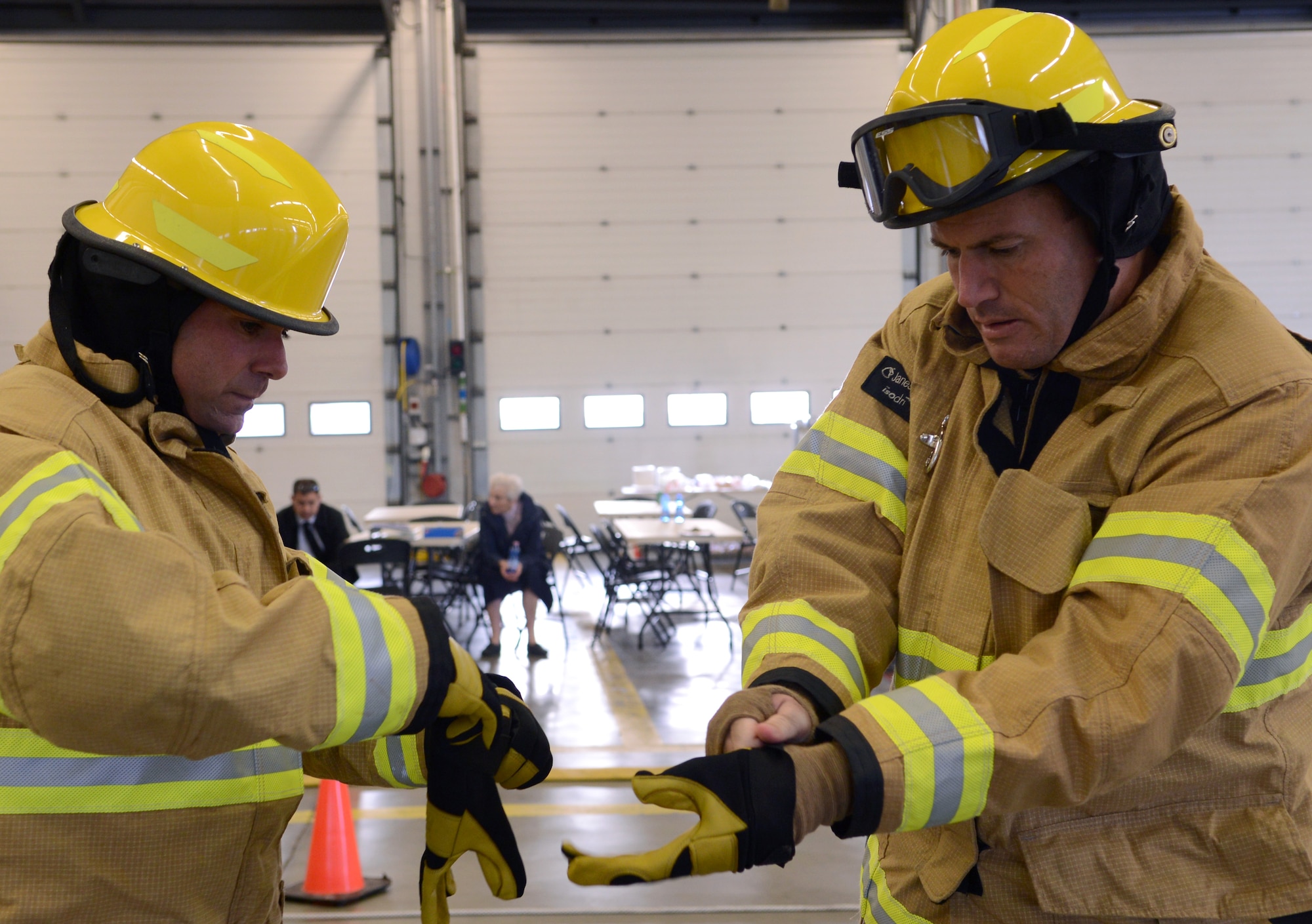 U.S. Air Force Lt. Col. Albert Frank, left, 100th Mission Support Group deputy commander, and U.S. Air Force Col. Kenneth T. Bibb Jr., 100th Air Refueling Wing commander, finish putting on firefighter gear Oct. 17, 2014, during the Fire Prevention Week “Chiefs versus Eagles” fire muster on RAF Mildenhall, England. The muster required teams to perform a series of firefighter-related physical activities in the shortest amount of time possible. (U.S. Air Force photo/Airman 1st Class Dillon Johnston/Released)