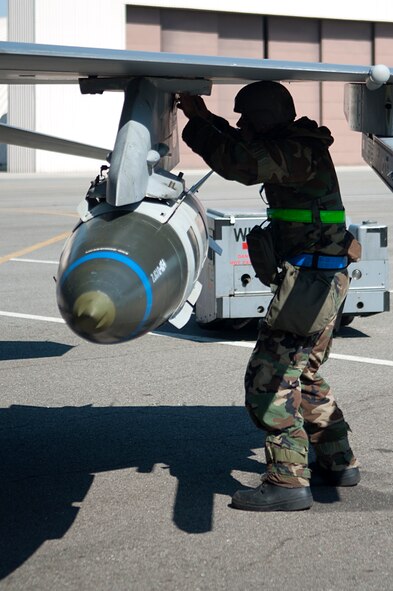 Senior Airman Miguel Acosta, 8th Aircraft Maintenance Squadron 80th Aircraft Maintenance Unit weapons load crew member, Kunsan Air Base, Republic of Korea, does a post bomb load check during a quarterly load crew competition at Osan Air Base, ROK, Oct. 17, 2014. Weapons load crew competitions are conducted quarterly to keep Airmen sharp and recognize superior performers. (U.S. Air Force photo by Senior Airman Matthew Lancaster)