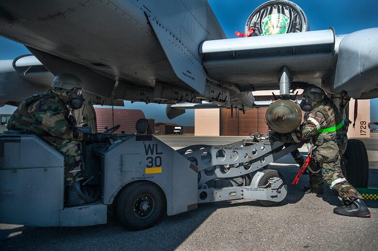 Senior Airman Benjamin Lilley, 51st Aircraft Maintenance Squadron 25th Aircraft Maintenance Unit weapons load crew member, and Staff Sgt. Kenneth Nelems, 51st AMXS 25th AMU weapons load crew team chief, load a Mark-82 bomb onto an A-10 Thunderbolt II during a quarterly load crew competition at Osan Air Base, Republic of Korea, Oct. 17, 2014. Load crews are tested on their ability to complete tasks during monthly proficiency loads, quarterly evaluations and the everyday mission to participate in the competition. (U.S. Air Force photo by Senior Airman Matthew Lancaster)