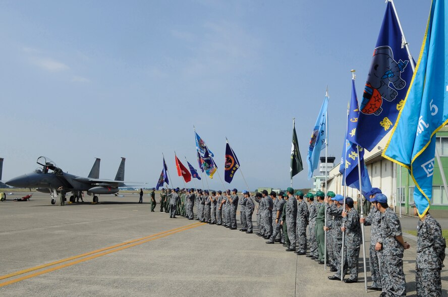 Japanese Air Self-Defense Force's 5th Air Wing greets 67th Fighter Squadron pilots from Kadena Air Base, Japan, after they landed on Nyutabaru Air Base, Japan, Oct. 18. 2014. The 5th AW, 8th AW and the 67th FS will participate in a two week-long bilateral Aviation Training Relocation Program to build operational readiness and interoperability. (U.S. Air Force photo by Senior Airman Marcus Morris/Released)
