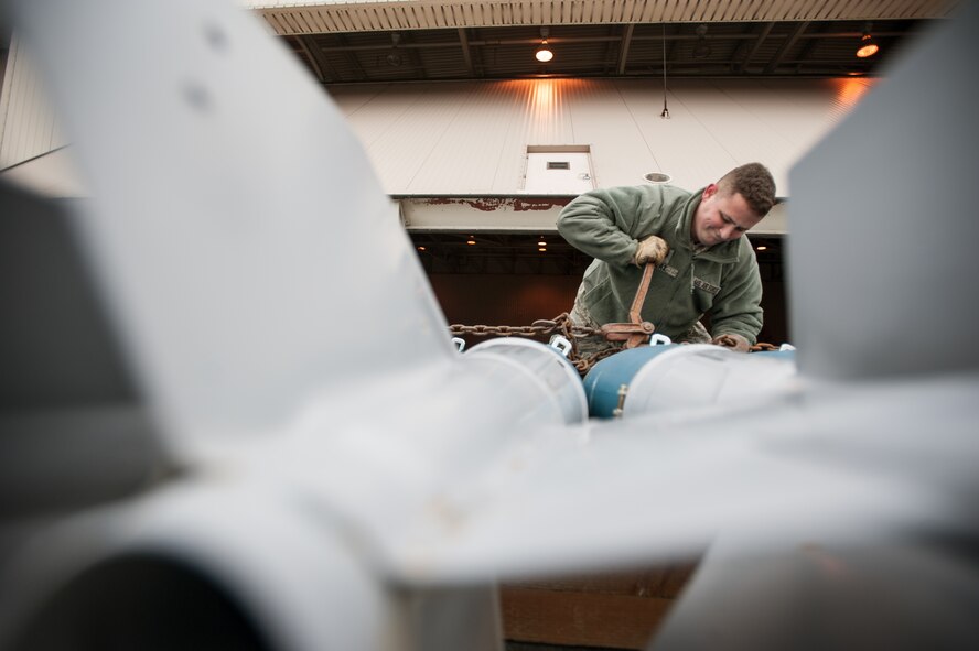 Senior Airman Dale Hart, 8th Maintenance Squadron munitions systems crew chief, loads F-16 Fighting Falcon training munitions onto a trailer during RED FLAG-Alaska 15-1 at Eielson Air Force Base, Oct. 15, 2014. RF-A provides training for deployed maintenance and support personnel in sustainment of large-force deployed air operations and is a Pacific Air Forces-directed field training exercise for U.S. and international forces flown under simulated air combat conditions. (U.S. Air Force photo by Senior Airman Taylor Curry/Released)