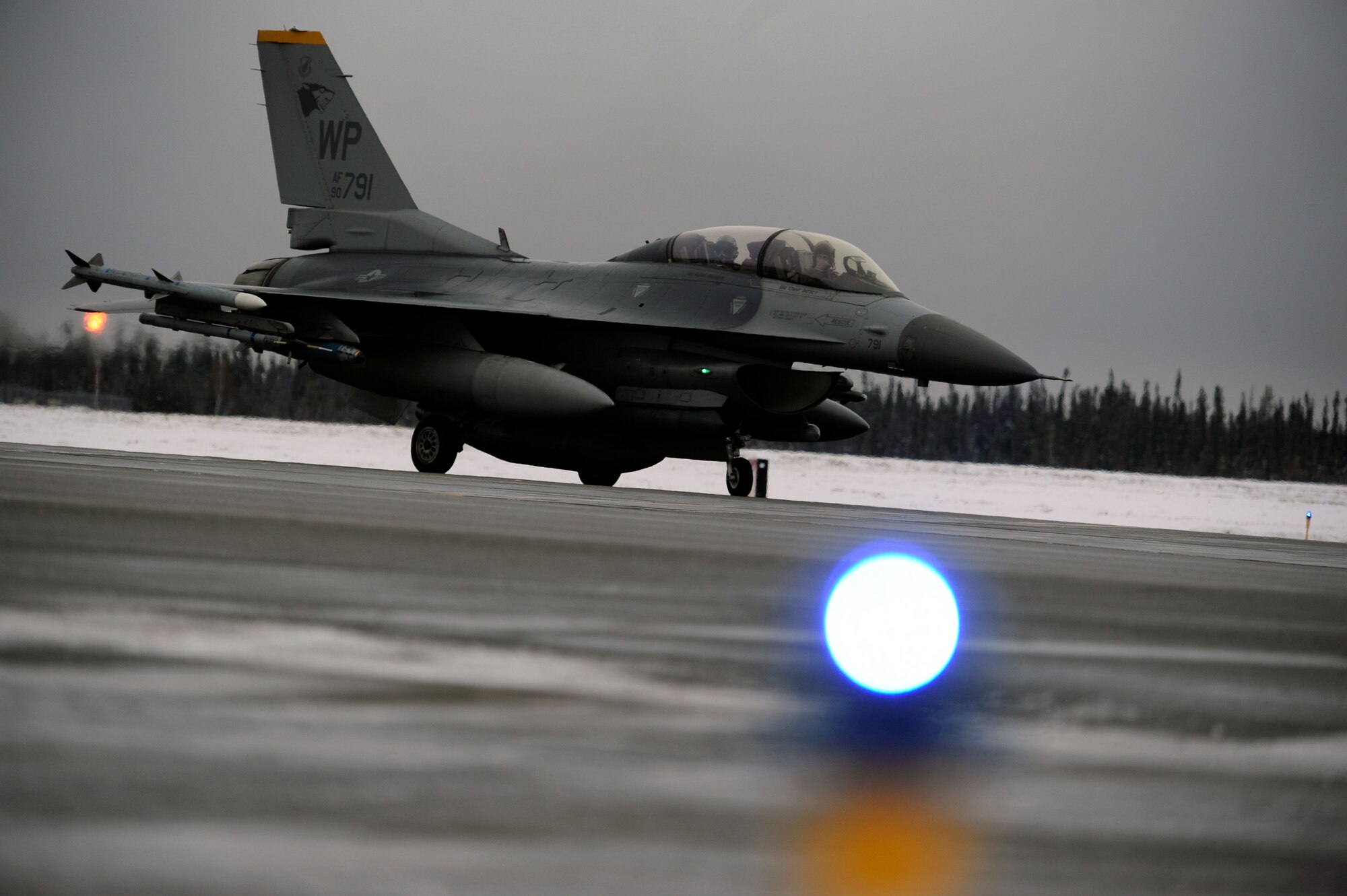 An F-16 Fighting Falcon from Kunsan Air Base, Republic of Korea, taxis during RED FLAG-Alaska 15-1 at Eielson Air Force Base, Oct. 14, 2014. This field training exercise is focused on improving the combat readiness of U.S. and international forces and providing training for units preparing for air expeditionary force tasking. (U.S. Air Force photo by Senior Airman Taylor Curry/Released)