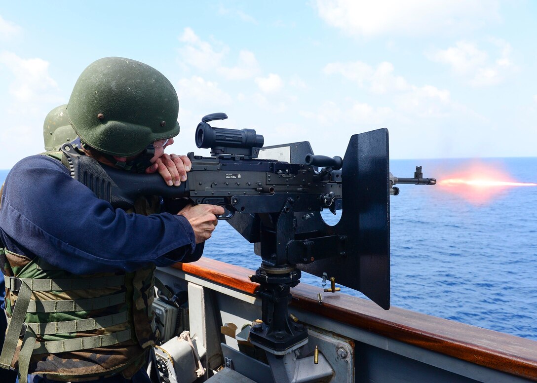 U.S. Navy Ensign John Bishop participates in a live fire training exercise with an M240B light machine gun on the guided missile destroyer USS Sterett. The Sterett is part of the Carl Vinson Carrier Strike Group, which is supporting maritime security operations, strike operations in Iraq and Syria as directed, and theater security cooperation efforts in the U.S. 5th Fleet area of responsibility in the Indian Ocean, Oct. 16, 2014. 