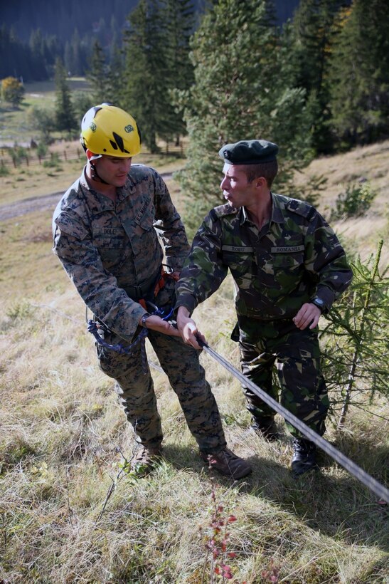 U.S. Marines and sailors from Black Sea Rotational Force 14 participated in Platinum Lynx 14.6 in the Carpathian Mountains from Sept. 29 to Oct. 3 in Miercurea Ciuc, Romania. Knowledge and understanding of skills and tactics in mountain regions was shared between the Marines and Romanian Land Forces to help sustain readiness in any location. Service members trained with the 61st Mountain Troops Brigade from the Romanian Land Forces in rappelling, rock climbing, a live-fire range and survival skills. The exercise concluded with a 15-kilometer troop movement in high-elevation terrain. (U.S. Marine Corps photo by Lance Cpl. Ryan Young/released)