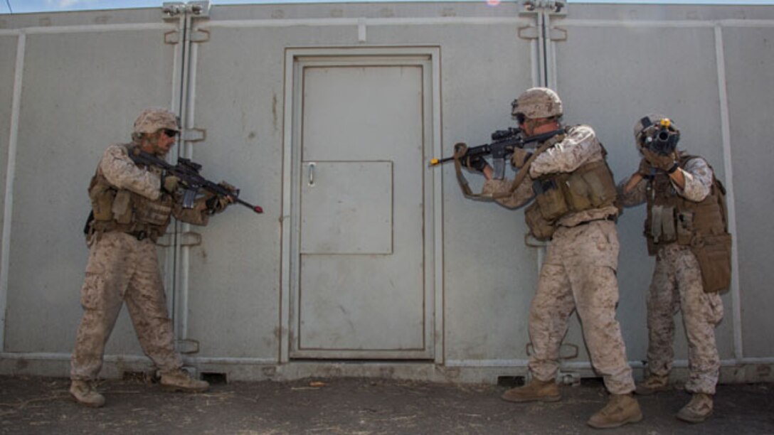 U.S. Marines with Battalion Landing Team, 3rd Battalion, 1st Marine Regiment, 15th Marine Expeditionary Unit, prepare to breach a door during a helicopter-raid exercise aboard Camp Pendleton, Calif., Oct. 16, 2014. BLT 3/1 is scheduled to deploy as the 15th MEU’s ground combat element next spring. (U.S. Marine Corps photo by Sgt. Emmanuel Ramos/Released)