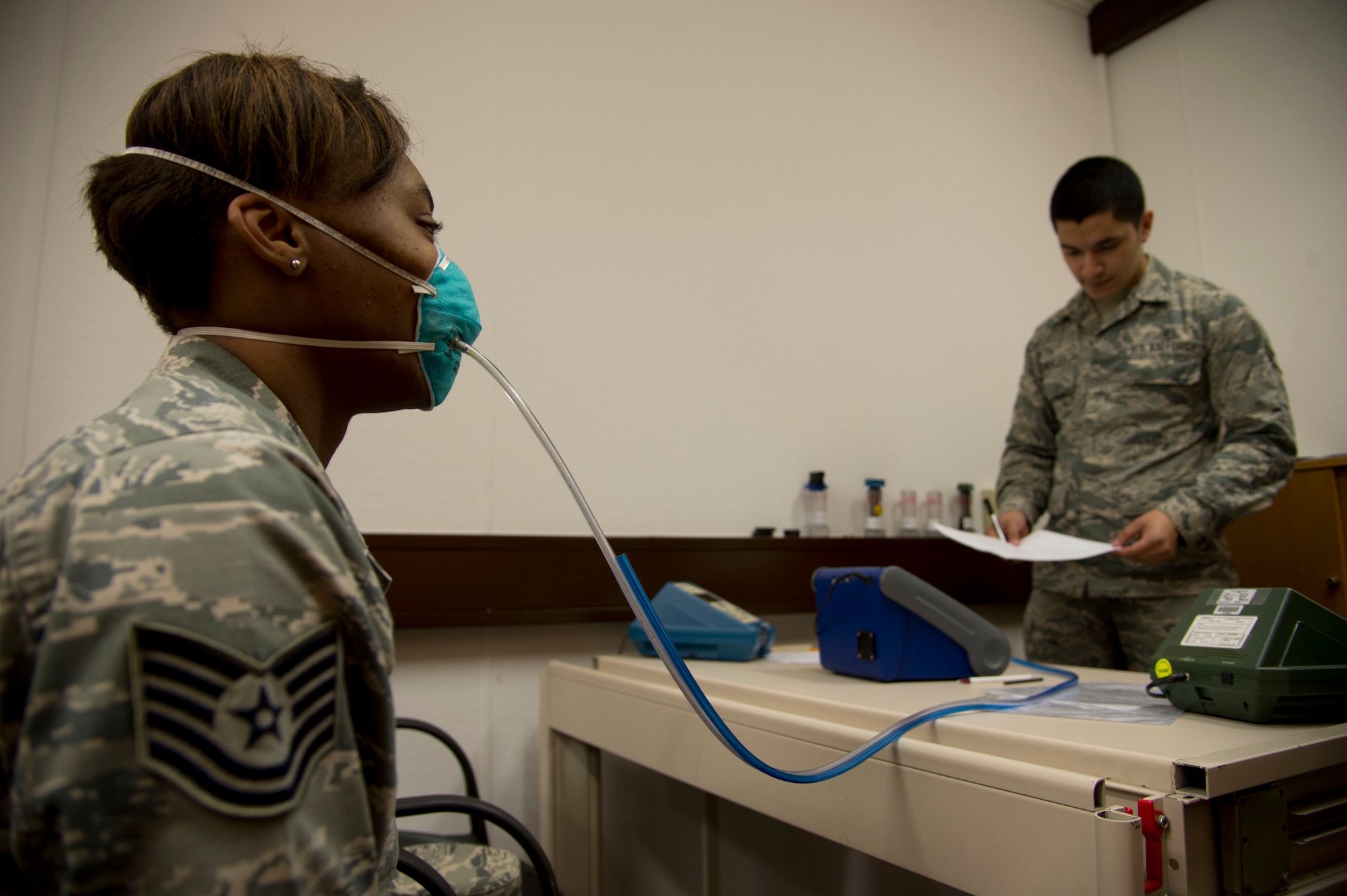 Tech. Sgt. Saquadrea Crosby gets fitted for an N95 respirator by Airman 1st Class Aaron Gonzalez  Oct. 17, 2014, at Ramstein Air Base, Germany. The N95 respirator is a device that is used to help prevent the spread of germs (viruses and bacteria) from one person to another. As members of the 86th Airlift Wing continue to support missions for Operation United Assistance, Airmen who are expected to interact with returnees from Ebola affected areas will be fitted for the N95 respirators. Crosby is the 86th Aerospace Medicine Squadron public health NCO in charge and Gonzalez is an 86th Bioenvironmental Engineering technician. (U.S. Air Force photo/Staff Sgt. Sara Keller)