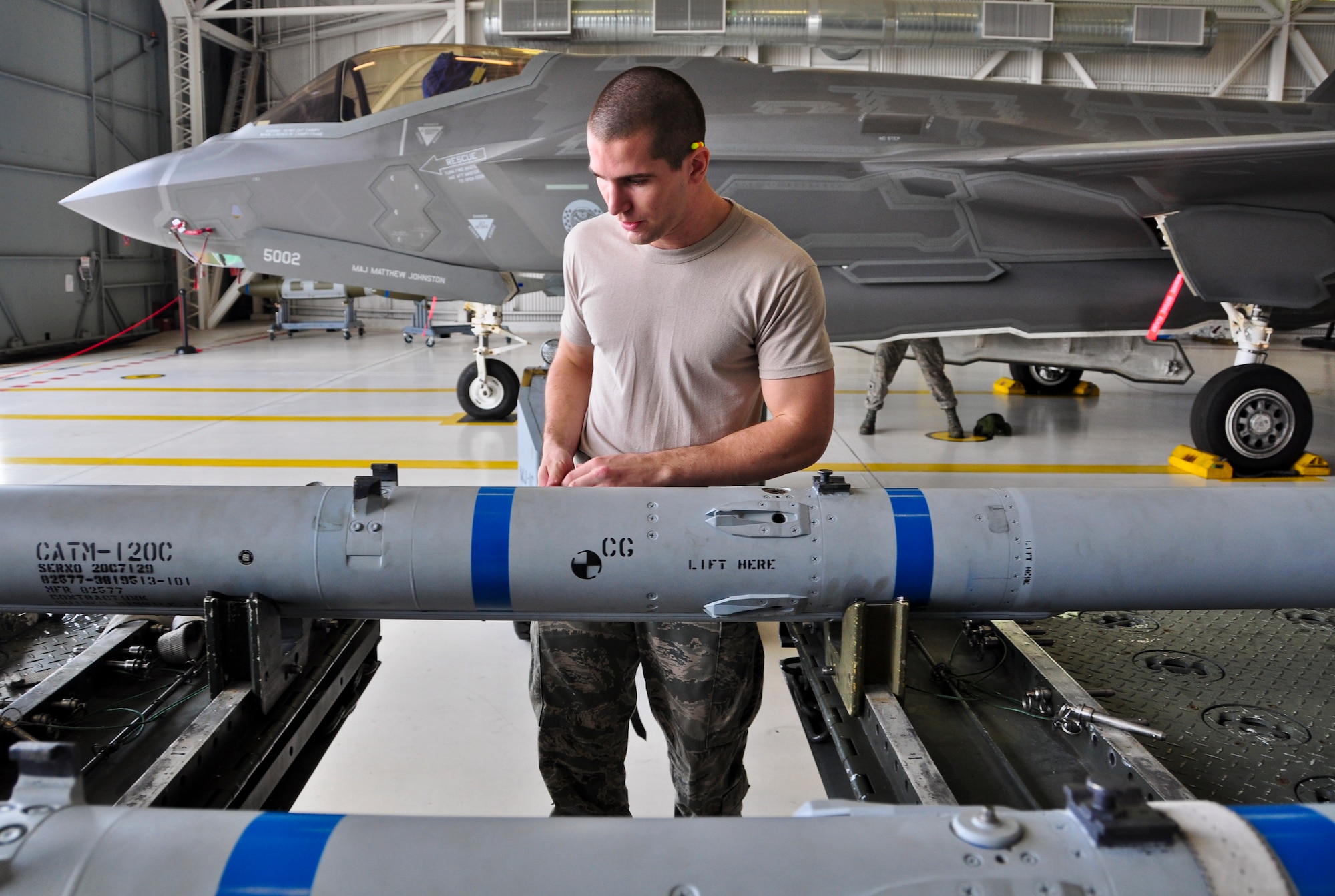 Airman 1st Class Reece Zoller makes an AIM-120 advanced medium-range air-to-air missile safe before loading it onto an F-35A Lightning II during a qualification load Oct. 10, 2014, at Eglin Air Force Base, Fla. The F-35 training program at Eglin AFB currently serves as the primary source of F-35 expertise to new F-35A units across the Air Force. Zoller is a load crewmember from the 58th Aircraft Maintenance Unit crew one. (U.S. Air Force photo/Staff Sgt. Marleah Robertson)