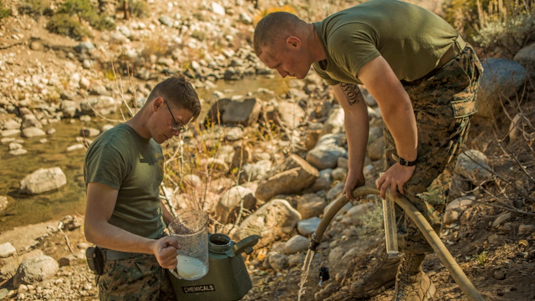 U.S. Marine Corps water support technicians with Headquarters and Service Company, Combat Logistics Battalion 6, 2nd Marine Logistics Group, purify river water using the Lightweight Water Purification System at Mountain Warfare Training Center, Bridgeport, California, October 20, 2014. CLB-6 stayed at MWTC to attend the basic mobility course and to provide logistical support to 2nd Battalion 5th Marine Regiment, 1st Marine Division. (U.S. Marine Corps photo by Cpl. Desire M. Mora/Released)