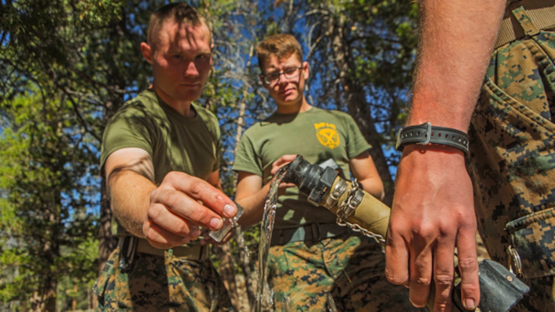 U.S. Marine Corps water support technicians with Headquarters and Service Company, Combat Logistics Battalion 6, 2nd Marine Logistics Group, purify river water using the Lightweight Water Purification System at Mountain Warfare Training Center, Bridgeport, California, October 20, 2014. CLB-6 stayed at MWTC to attend the basic mobility course and to provide logistical support to 2nd Battalion 5th Marine Regiment, 1st Marine Division. (U.S. Marine Corps photo by Cpl. Desire M. Mora/Released)