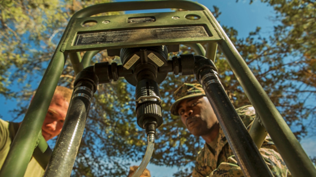 U.S. Marine Corps water support technicians with Headquarters and Service Company, Combat Logistics Battalion 6, 2nd Marine Logistics Group, purify river water using the Lightweight Water Purification System at Mountain Warfare Training Center, Bridgeport, California, October 20, 2014. CLB-6 stayed at MWTC to attend the basic mobility course and to provide logistical support to 2nd Battalion 5th Marine Regiment, 1st Marine Division. (U.S. Marine Corps photo by Cpl. Desire M. Mora/Released)
