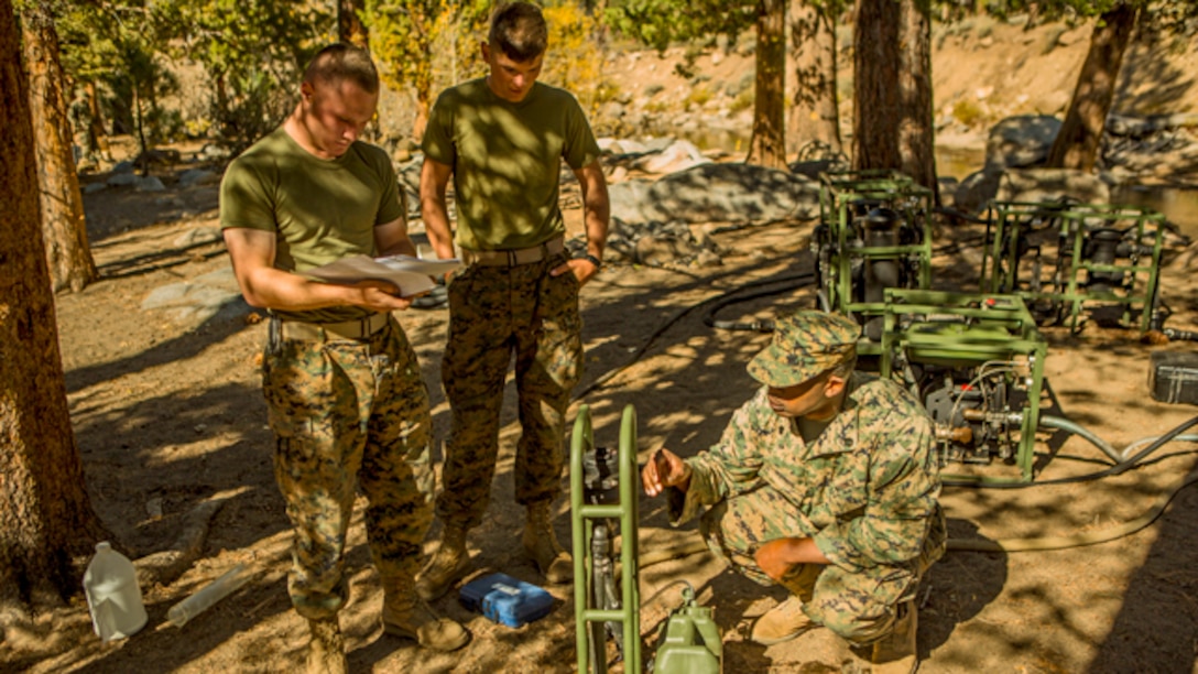 U.S. Marine Corps water support technicians with Headquarters and Service Company, Combat Logistics Battalion 6, 2nd Marine Logistics Group, purify river water using the Lightweight Water Purification System at Mountain Warfare Training Center, Bridgeport, California, October 20, 2014. CLB-6 stayed at MWTC to attend the basic mobility course and to provide logistical support to 2nd Battalion 5th Marine Regiment, 1st Marine Division. (U.S. Marine Corps photo by Cpl. Desire M. Mora/Released)