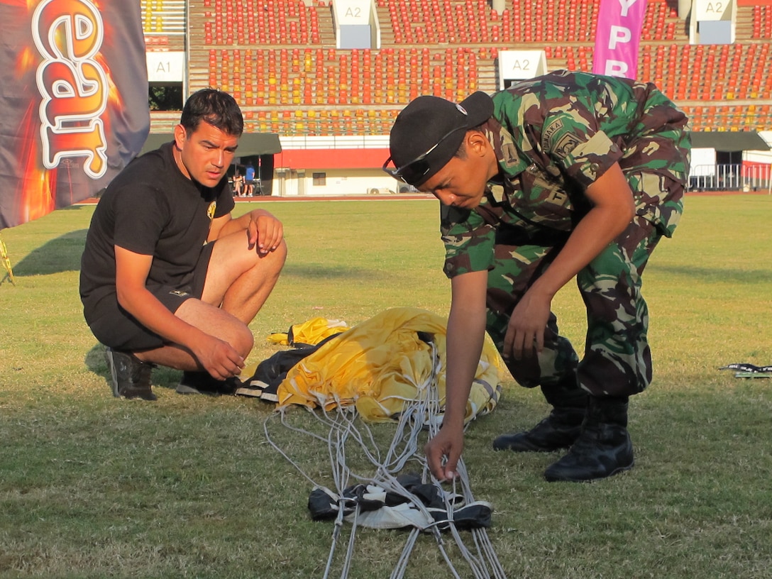 SFC Christopher Acevedo and US Liaison Indra packing a parachute at the 38th Conseil International du Sport Militaire (CISM) in Solo, Indonesia 17-28 September