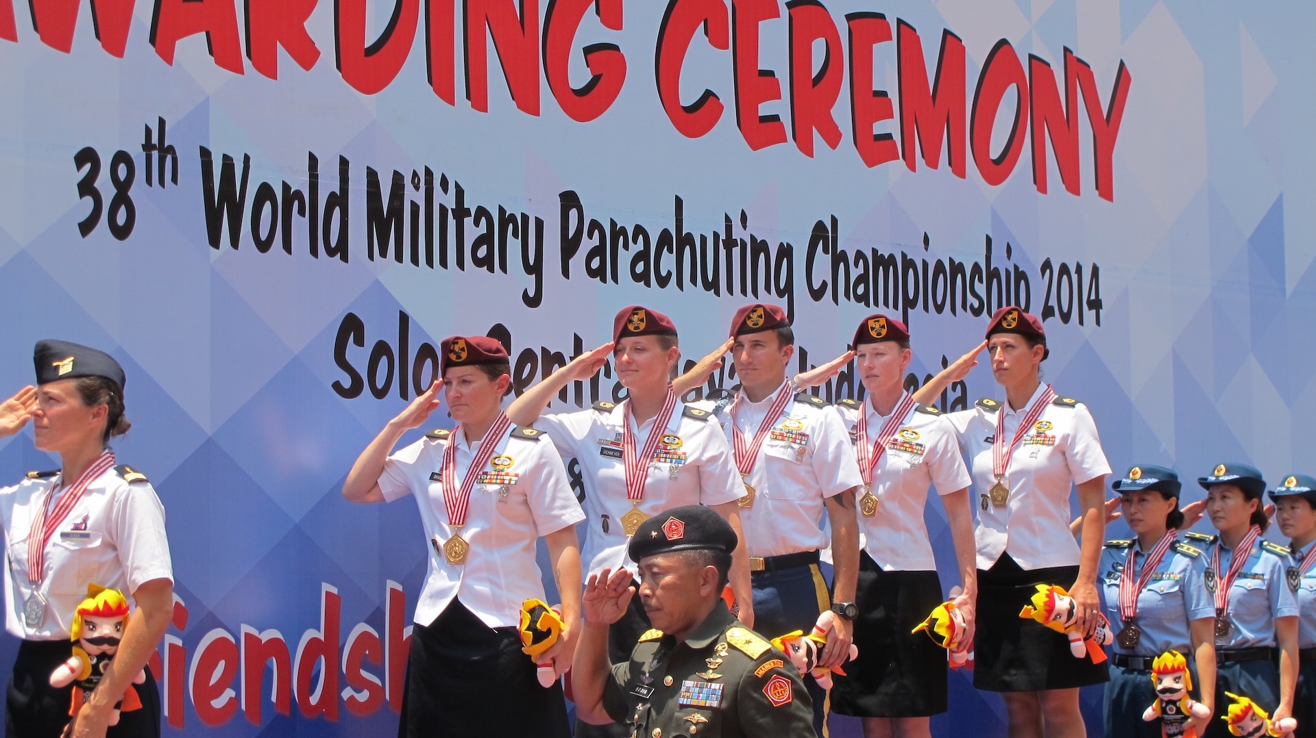US Women's team on the podium salute as the US National Anthem plays at the 38th Conseil International du Sport Militaire (CISM) in Solo, Indonesia 17-28 September