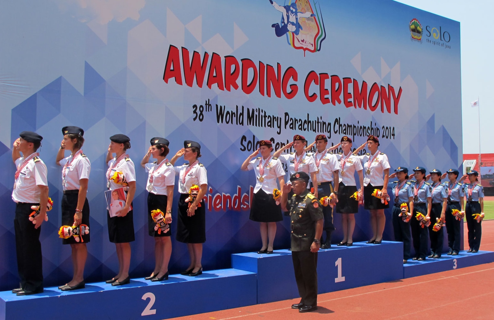 US Women's team on the podium salute as the US National Anthem plays SFC Jennifer Davidson, SFC Laura Dickmeyer, SSG Matt Navarro, SFC Angela Nichols, SFC Dannielle Woosley at the 38th Conseil International du Sport Militaire (CISM) in Solo, Indonesia 17-28 September