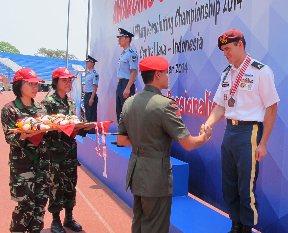 SGT Daniel Osorio shakes hands with the medal presenter