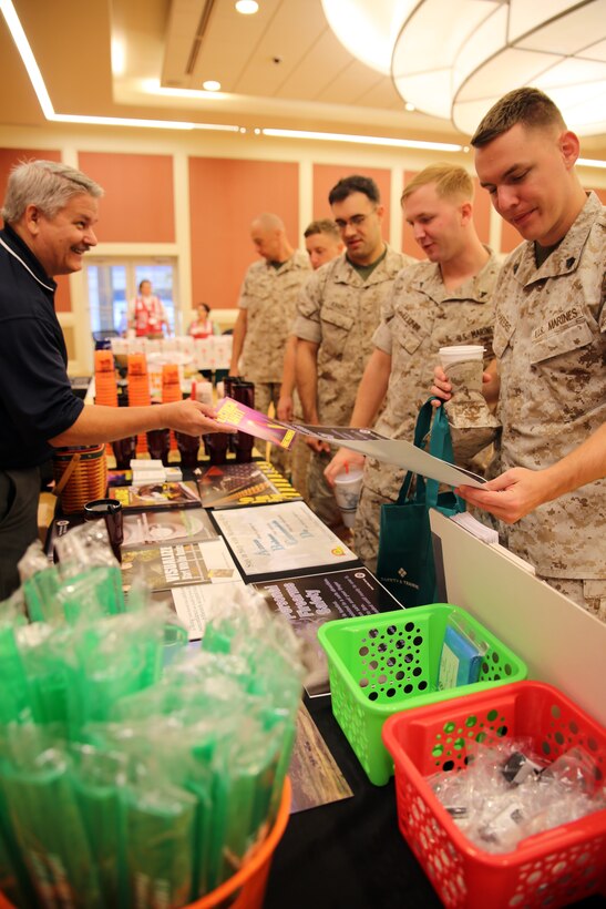 Marines with II Marine Expeditionary Force collect informational material and practical gifts from a II MEF Safety representative during the II MEF Safety Expo at Marine Corps Base Camp Lejeune, N.C., Oct. 22, 2014. More than 20 local, state and federal organizations from across the nation set up tables to provide unique information on a wide array of safety subjects. Over the seven-hour period the event was open, approximately 1,500 Marines and sailors took time away from their work schedules to attend the expo.  (U.S. Marine Corps photo by Sgt. Paul Robbins Jr. / Released)