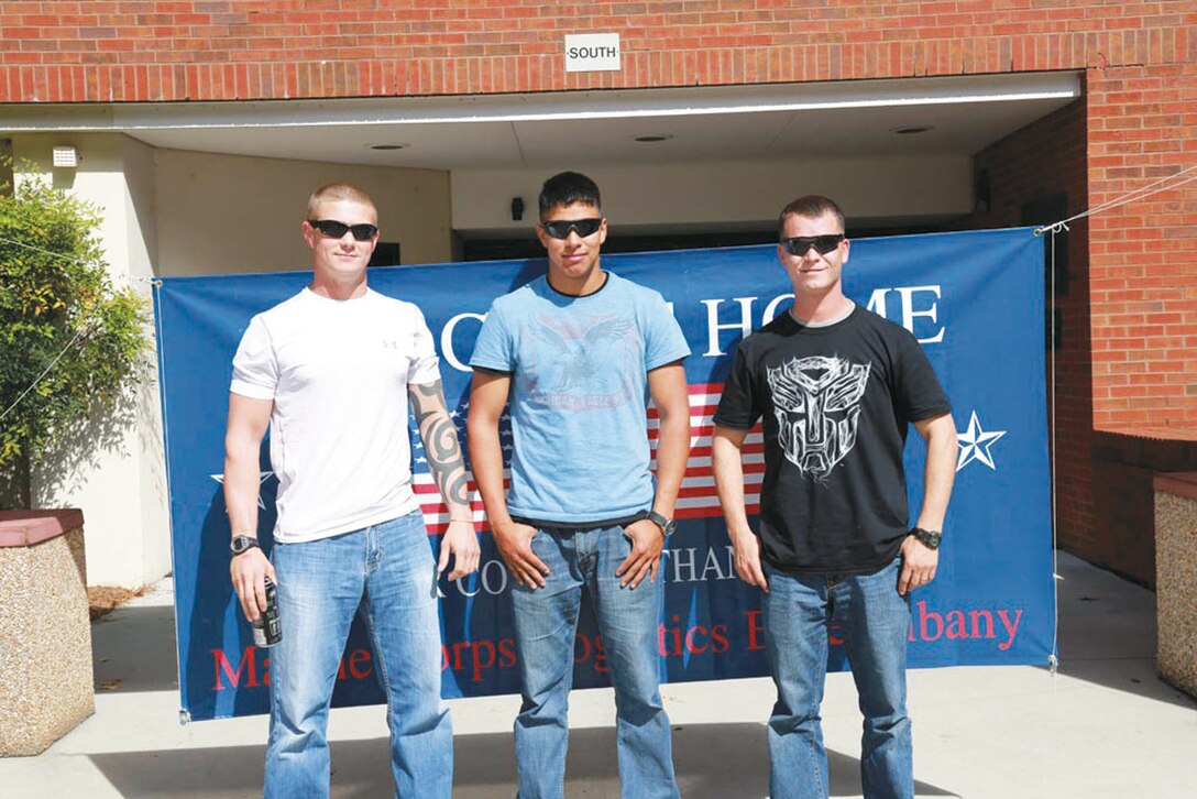 Three Marines return home from a tour of duty in Afghanistan. (From left) Staff Sgt. Donald Snyder, Cpl. Jacob Colvin and Sgt. Michael Barnhill with Marine Corps Logistics Command, deployed April 19. They were reunited with friends and their families Oct. 15. 