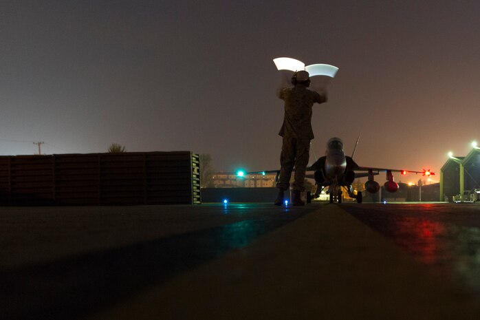 Gunnery Sgt. Osvaldo Rincon, powerline division chief with Marine All-Weather Fighter Attack Squadron 533, guides an F-18/A Hornet aboard Osan Air Base, Republic of Korea, to participate in the Korean Marine Exchange Program 14-13, Oct. 9, 2014, to increase the combat readiness of Marine Aircraft Group 12, improve its operating skills as a Marine Air-Ground Task Force and enhance joint and combined integration with the U.S. Air Force and ROK Marine Corps. KMEP 14-13 is a multinational exercise that focuses on the integration of aviation and ground assets within the construct of a traditional Combined Arms Live Fire Exercise. Supporting units include, but are not limited to, Marine Aviation Logistics Squadron 12 and Marine Wing Support Squadron 171.