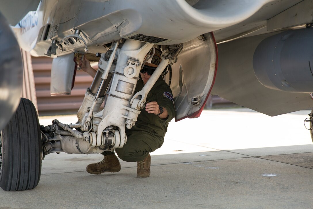 Sgt. Jeffrey Failing, a powerline mechanic with Marine All-Weather Fighter Attack Squadron 533, conducts a maintenance check on an F/A-18 Hornet during the Korean Marine Exchange Program 14-13, Oct. 13, 2014, on Osan Air Base, Republic of Korea. KMEP 14-13 is a multinational exercise that focuses on the integration of aviation and ground assets within the construct of a traditional Combined Arms Live Fire Exercise. Supporting units include, but are not limited to, Marine Aviation Logistics Squadron 12 and Marine Wing Support Squadron 171.
