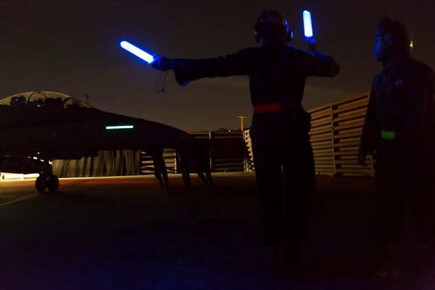 Private First Class Gerald Tompkins, a powerline mechanic with Marine All-Weather Fighter Attack Squadron 533, signals to an F/A-18 Hornet during the Korean Marine Exchange Program 14-13, Oct. 13, 2014, on Osan Air Base, Republic of Korea. KMEP 14-13 is a multinational exercise that focuses on the integration of aviation and ground assets within the construct of a traditional Combined Arms Live Fire Exercise. Supporting units include, but are not limited to, Marine Aviation Logistics Squadron 12 and Marine Wing Support Squadron 171.