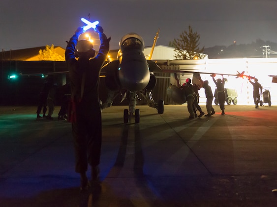 Lance Cpl. Bobby Tyler, a plane captain with Marine All-Weather Fighter Attack Squadron 533, signals to an F/A-18 Hornet during the Korean Marine Exchange Program 14-13, Oct. 13, 2014, on Osan Air Base, Republic of Korea. KMEP 14-13 is a multinational exercise that will focus on the integration of aviation and ground assets within the construct of a traditional Combined Arms Live Fire Exercise. Supporting units include, but are not limited to, Marine Aviation Logistics Squadron 12 and Marine Wing Support Squadron 171.