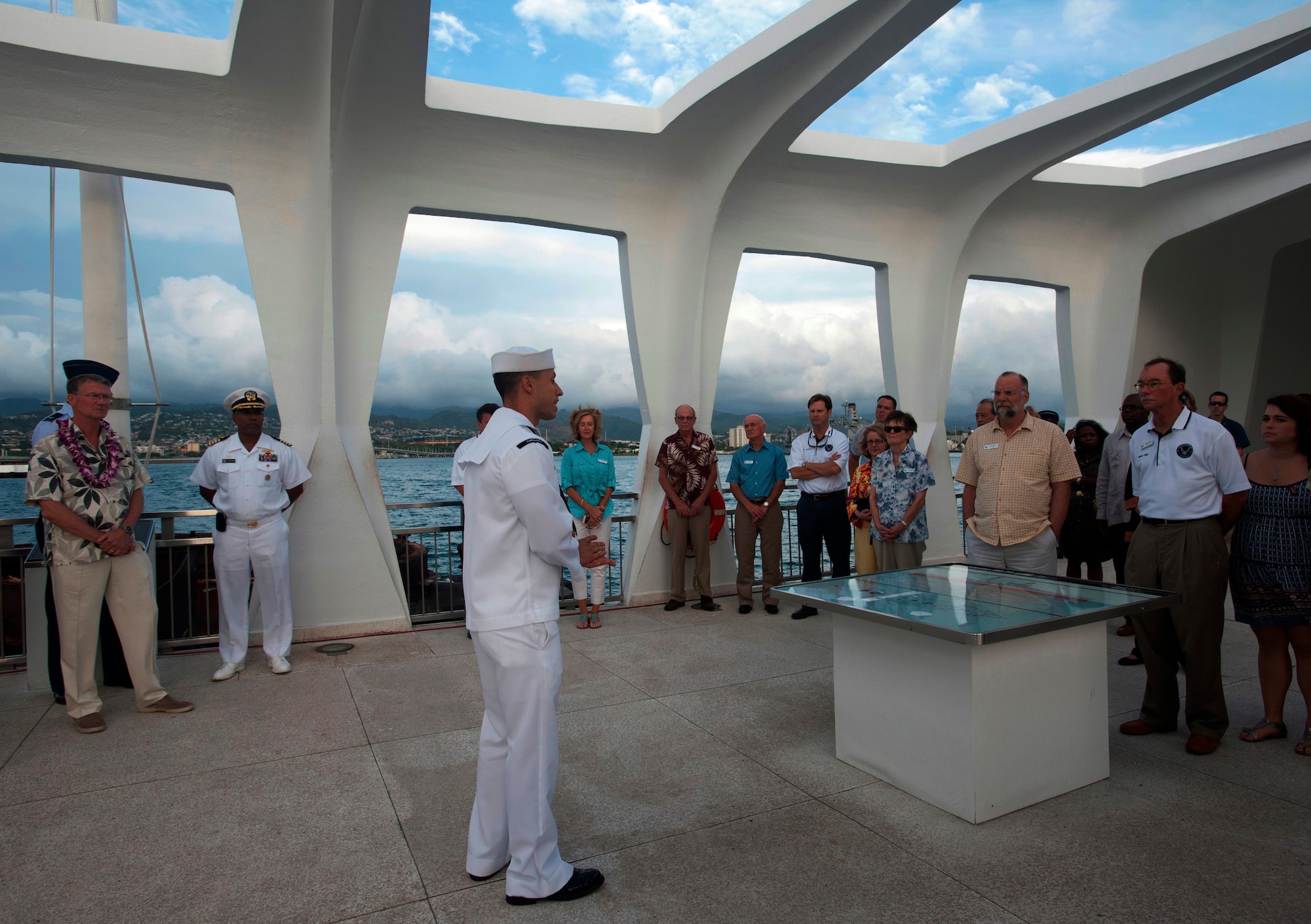 A Sailor briefs members of the Air Force Civic Leader Program during the group’s visit to the USS Arizona Memorial, Oct. 14, 2014, at Joint Base Pearl Harbor-Hickam. At the invitation of Gen. Mark Welsh III, Air Force Chief of Staff, and hosted by Pacific Air Forces, the civic leaders spent three days visiting military installations and units to gain a hands-on understanding of the missions and capabilities of the Air Force, Army, Marine Corps, Navy and Coast Guard, and their respective contributions to the Pacific Rebalance. (U.S. Air Force photo by Tech. Sgt. Lucelia Ball/Released) 