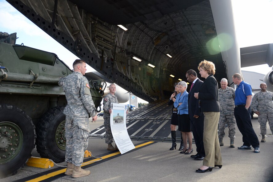 Spc. Denton Bennett (left), Cherokee Company 4th Battalion 423rd Infantry Regiment grenadier, explains the various capabilities of the M1126 infantry carrier vehicle to visitors Oct. 21, 2014, during the Joint Base Lewis-McChord Service Member for Life Transition Summit at JBLM, Wash. The group was able to learn about some of the equipment used by the Air Force and the Army. (U.S. Air Force photo/Airman 1st Class Keoni Chavarria)