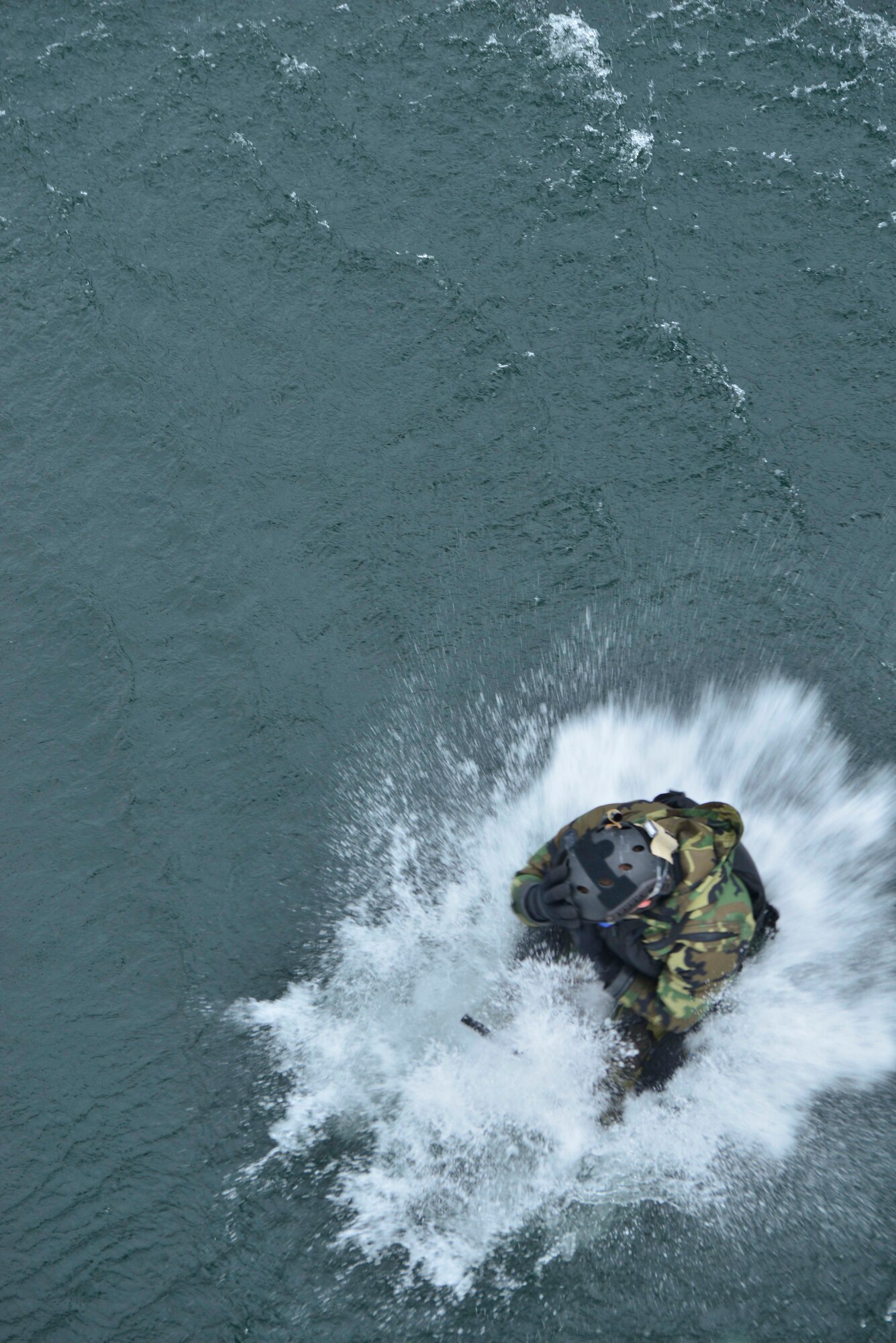 Capt. Matthew Arnold, 66th Training Squadron combat rescue officer, performs a ‘helo-cast’ out of a UH-1N Iroquois helicopter during a water operations training scenario Oct. 17, 2014, at Long Lake, Washington. Helo-casting is style of deployment that combat rescue officers use to enter the water in a time when minutes mean seconds to save a live.  (U.S. Air Force photo/Staff Sgt. Alexandre Montes)