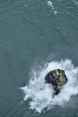 Capt. Matthew Arnold, 66th Training Squadron combat rescue officer, performs a ‘helo-cast’ out of a UH-1N Iroquois helicopter during a water operations training scenario Oct. 17, 2014, at Long Lake, Washington. Helo-casting is style of deployment that combat rescue officers use to enter the water in a time when minutes mean seconds to save a live.  (U.S. Air Force photo/Staff Sgt. Alexandre Montes)