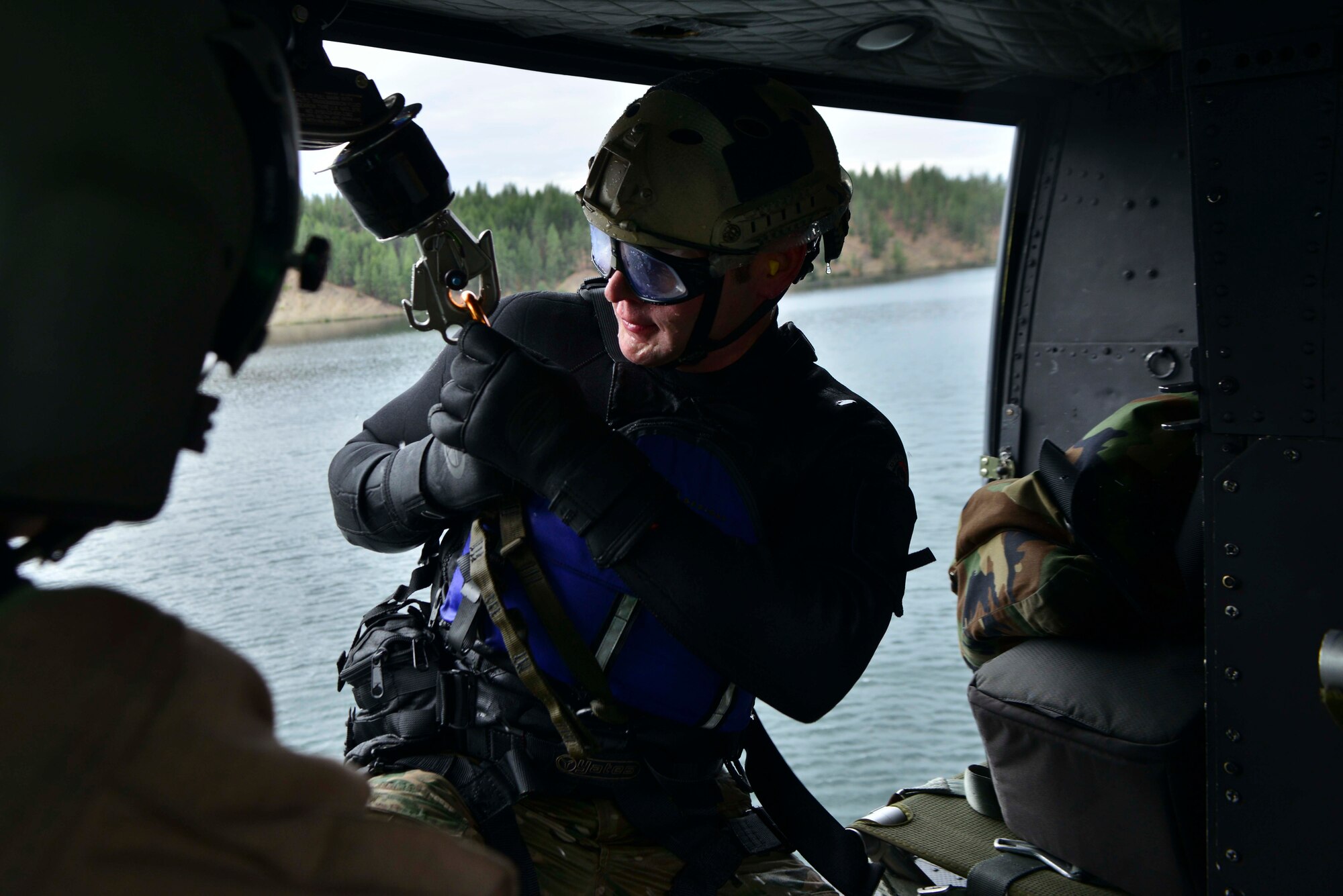Capt. Marcus Truman, 336th Training Group combat rescue officer, is hoisted back onto a UH-1N Iroquois helicopter during a water operations training scenario Oct. 17, 2014, at Long Lake, Washington. A complete water operations training mission would entail simulated recovery of isolated personnel in water situations with the participation of pilots and aircrews from the rescue flight or boat with support personnel aboard. Combat rescue officers are in charge of gathering safety teams to understand the mission, plan out a recovery strategy with aircrews, receive approval and execute the mission. (U.S. Air Force photo/Staff Sgt. Alexandre Montes)