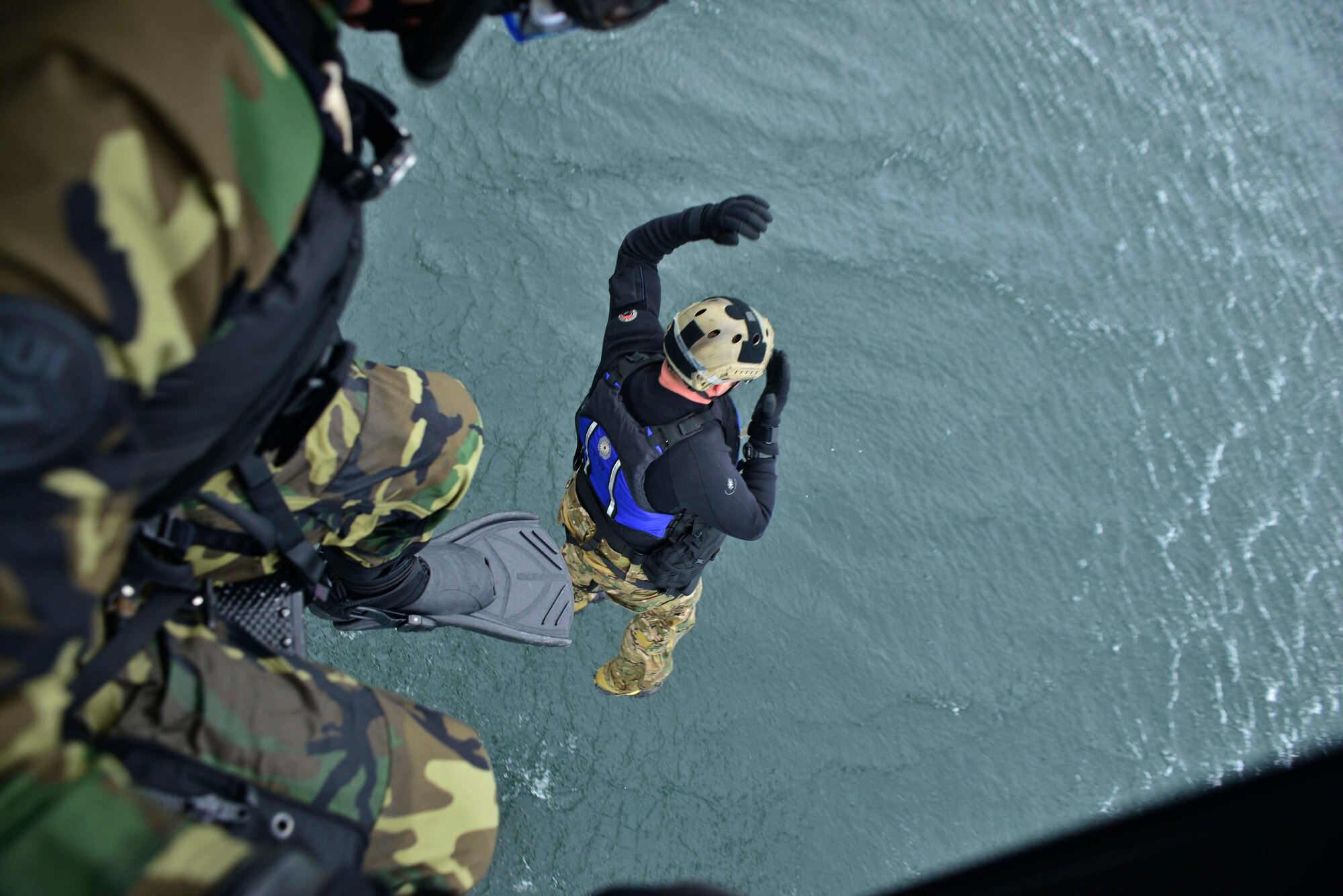 Capt. Marcus Truman, 336th Training Group combat rescue officer, freefall jumps out of a UH-1N Iroquois helicopter during water operations training scenario Oct. 17, 2014, at Long Lake, Washington. Truman was participating in the scenarios to stay current and proficient on his training as combat rescue officer.  Becoming a combat rescue officer entails an extraneous two-phase program that filters officer candidates, solidifying who can withstand high winds, rough seas, extreme weather, mental fatigue and still lead the mission at hand. In 2002, the Combat Rescue Officer program was instated by the Air Force chief of staff, with the vision of having expert leading Airmen in parachuting, personal recovery, diving, resistance during captivity. (U.S. Air Force photo/Staff Sgt. Alexandre Montes)