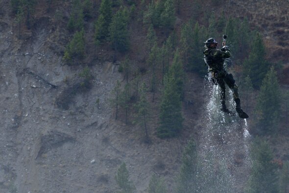 Capt. Matthew Arnold, 66th Training Squadron combat rescue officer, is hoisted onto a UH-1N Iroquois helicopter from the 36th Rescue Flight during a water operations training scenario Oct. 17, 2014, at Long Lake, Washington. Combat rescue officer, or CRO, is a career field that was created to strengthen Air Force personnel recovery capabilities. The CRO specialty includes direct combatant command and control of combat search and rescue operations. CRO’s and aircrews also train to perform these iterations in rough seas where a rescue hoist is not possible due to wave action.  In that instance, they must calculate their jump from the aircraft to land at the top of the wave to avoid freefalling too far and injuring themselves while entering the water.  All of this requires constant communication with the entire aircrew and practice. (U.S. Air Force photo/Staff Sgt. Alexandre Montes)