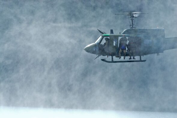 A UH-1N Iroquois helicopter from the 36th Rescue Flight hovers 10 feet above water looking for a potential landing zone during water operations training Oct. 17, 2014, at Long Lake, Washington. During the training, pilots and aircrew engineers from the 36th RQF from Fairchild Air Force Base recertified on water rescue operation procedures. The 36th RQF supports the U.S. Air Force Survival School training through hands-on helicopter operations for more than 3,000 students per year. Training is conducted year-round at Fairchild and at the school's field location in the Colville National Forest, about 60 miles north of the base. Flight operations include live rescue hoist training, paradrop demonstrations, and combat rescue procedures training for students in the basic Combat Survival Course. (U.S. Air Force photo/Staff Sgt. Alexandre Montes)