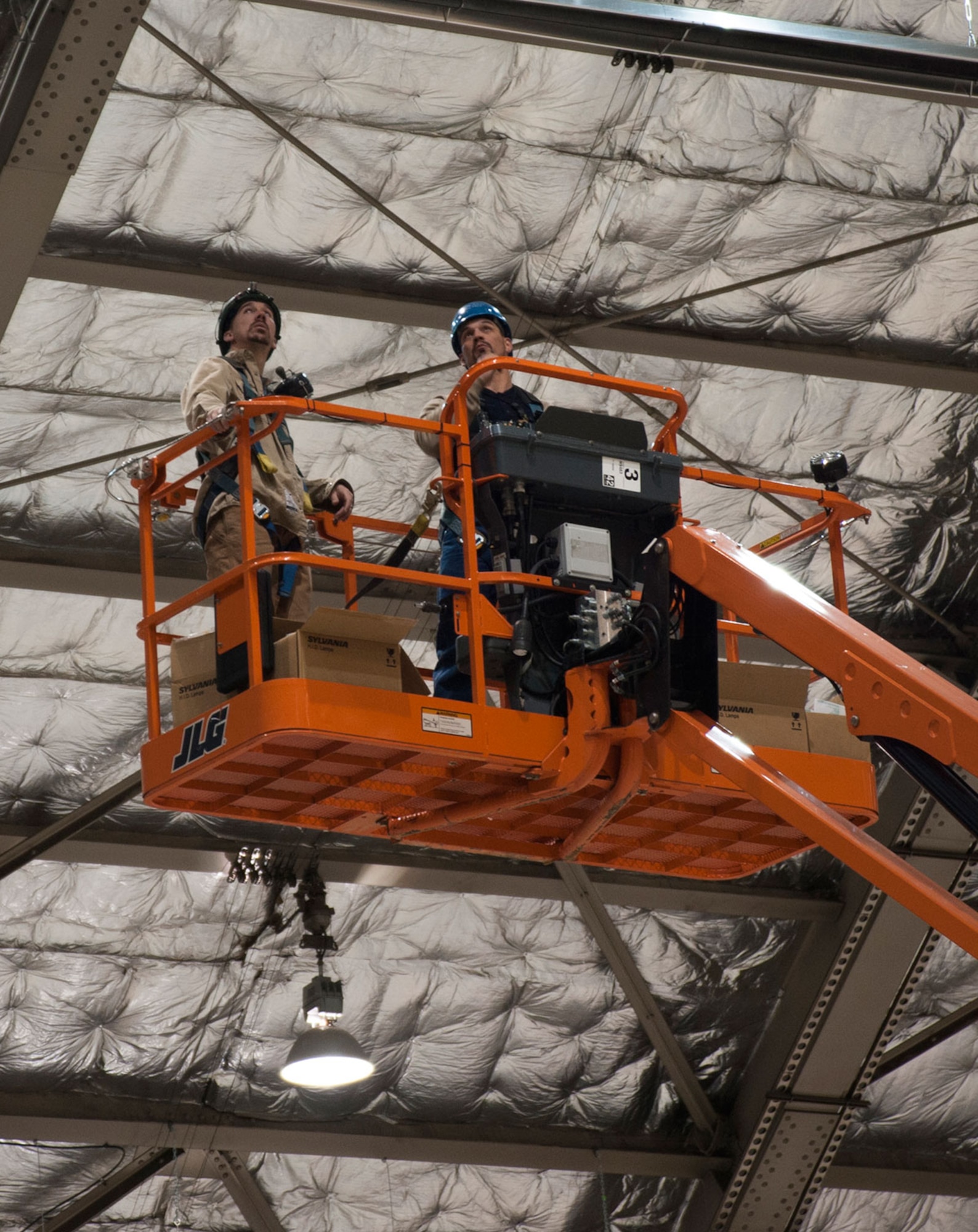 Preston Murfin and Raymond Clarke check for non-working high-intensity discharge light bulbs in Hangar 3 on Joint Base Elmendorf-Richardson, Alaska, Oct. 21, 2014. The lights are changed every three years with minimal maintenance from the 773d Civil Engineer Squadron’s Internal Electrical Shop. Murfin and Clarke are electrical engineers from the 773d CES. (U.S. Air Force photo/Airman 1st Class Tammie Ramsouer)