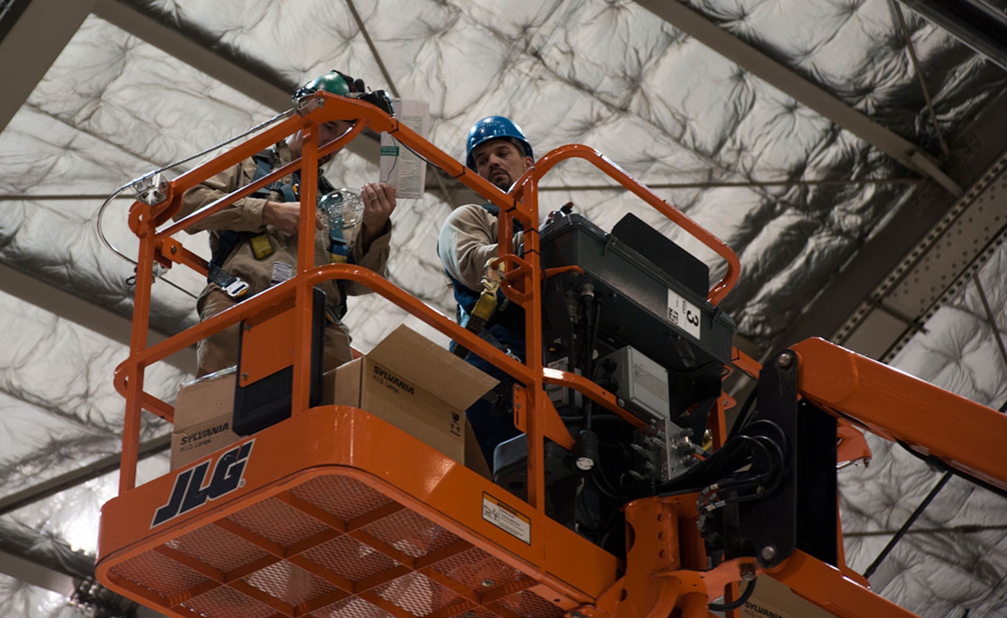 Preston Murfin and Raymond Clarke check high-intensity discharge light bulbs in Hangar 3 on Joint Base Elmendorf-Richardson, Alaska, Oct. 21, 2014. The lights are changed every three years with minimal maintenance from the 773d Civil Engineer Squadron’s Interior Electrical Shop. Murfin and Clarke are electrical engineers from the 773d CES. (U.S. Air Force photo/Airman 1st Class Tammie Ramsouer)