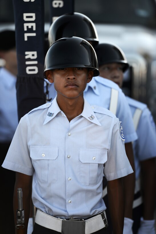 A member of the Del Rio High School’s Air Force Junior Reserve Officer Training Corps, TX-066, color guard prepares to present the colors at the Amistad Dam International Boundary and Water Commission on the United States and Mexico border, Oct. 17, 2014. The objectives of JROTC are to educate and train high school cadets in citizenship, promote community service, instill responsibility, character, and self-discipline, and provide instruction in air and space fundamentals. (U.S. Air Force photo by Staff Sgt. Steven R. Doty)(Released)